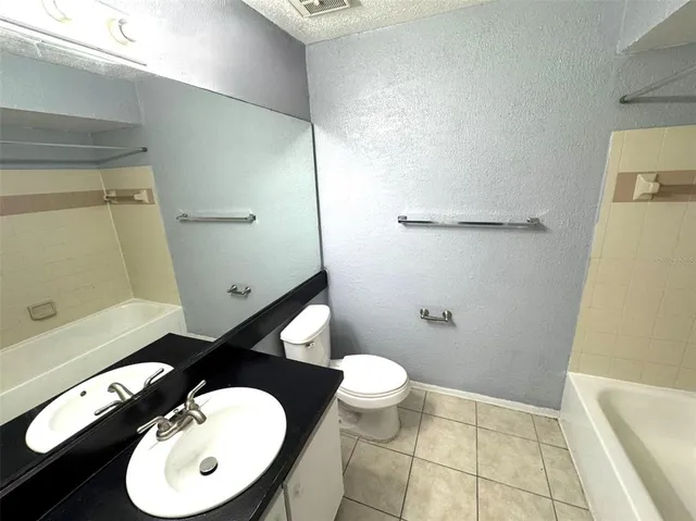 a bathroom with a toilet mirror and sink