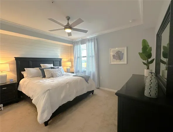 a bed room with a bed window and a flat screen tv