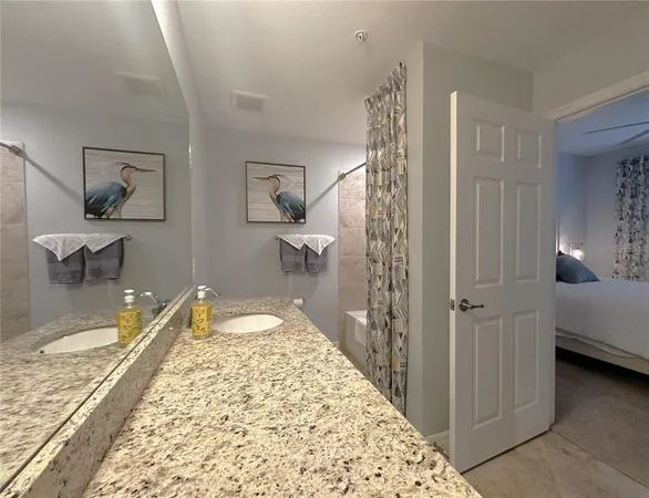 a spacious bedroom with a bed and a chandelier