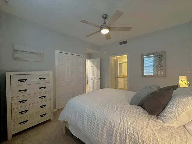 a bedroom with a bed and a night stand