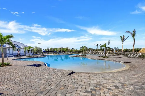 a view of a swimming pool and lake from nearby houses