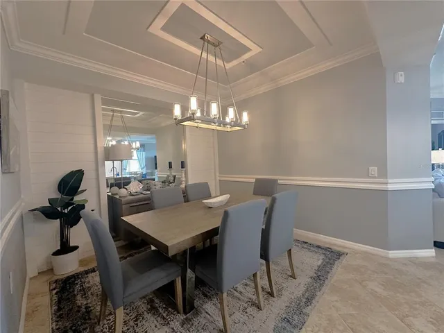 a view of a dining room with furniture and chandelier
