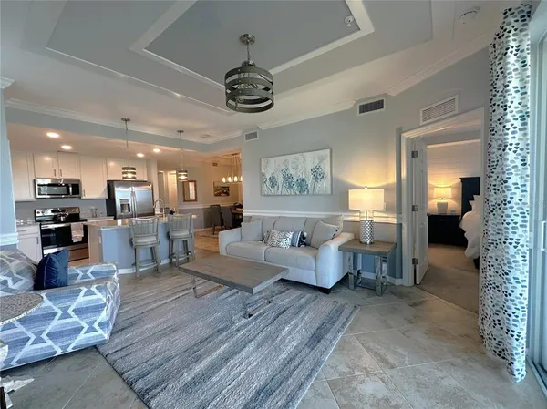 a living room with furniture and a chandelier