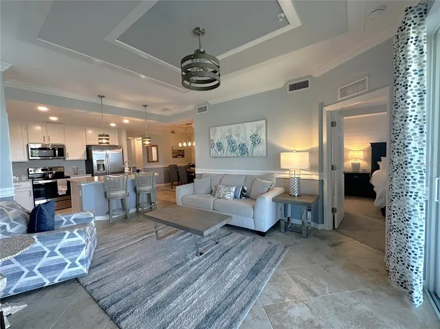 a living room with furniture and a chandelier