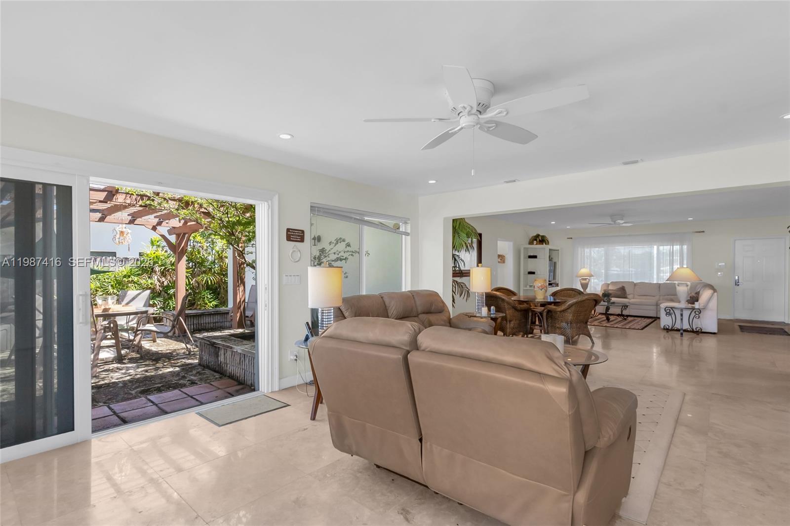 1995 Ixora Road North Miami, FL 33181 - Photo 16 of 30 a living room with furniture and a large window
