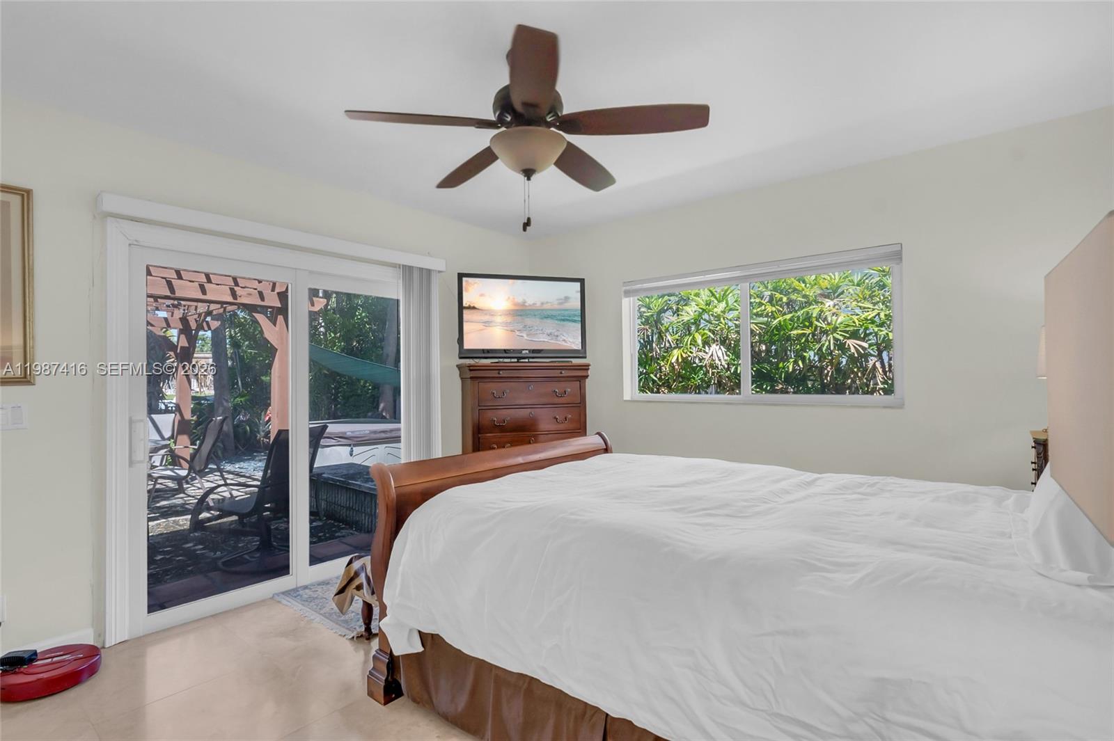 1995 Ixora Road North Miami, FL 33181 - Photo 22 of 30 a bedroom with a large bed and a window