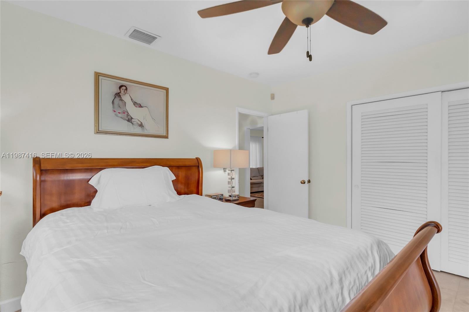 1995 Ixora Road North Miami, FL 33181 - Photo 23 of 30 a bedroom with a bed and painting on the wall