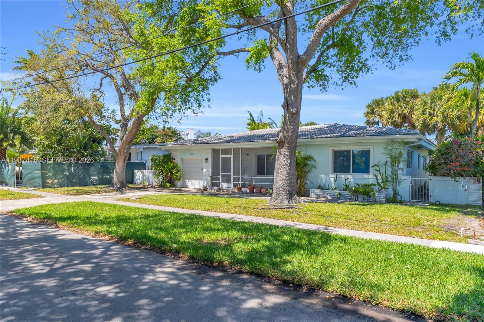 1995 Ixora Road North Miami, FL 33181 - Photo 4 of 30 a view of a house with swimming pool and a yard