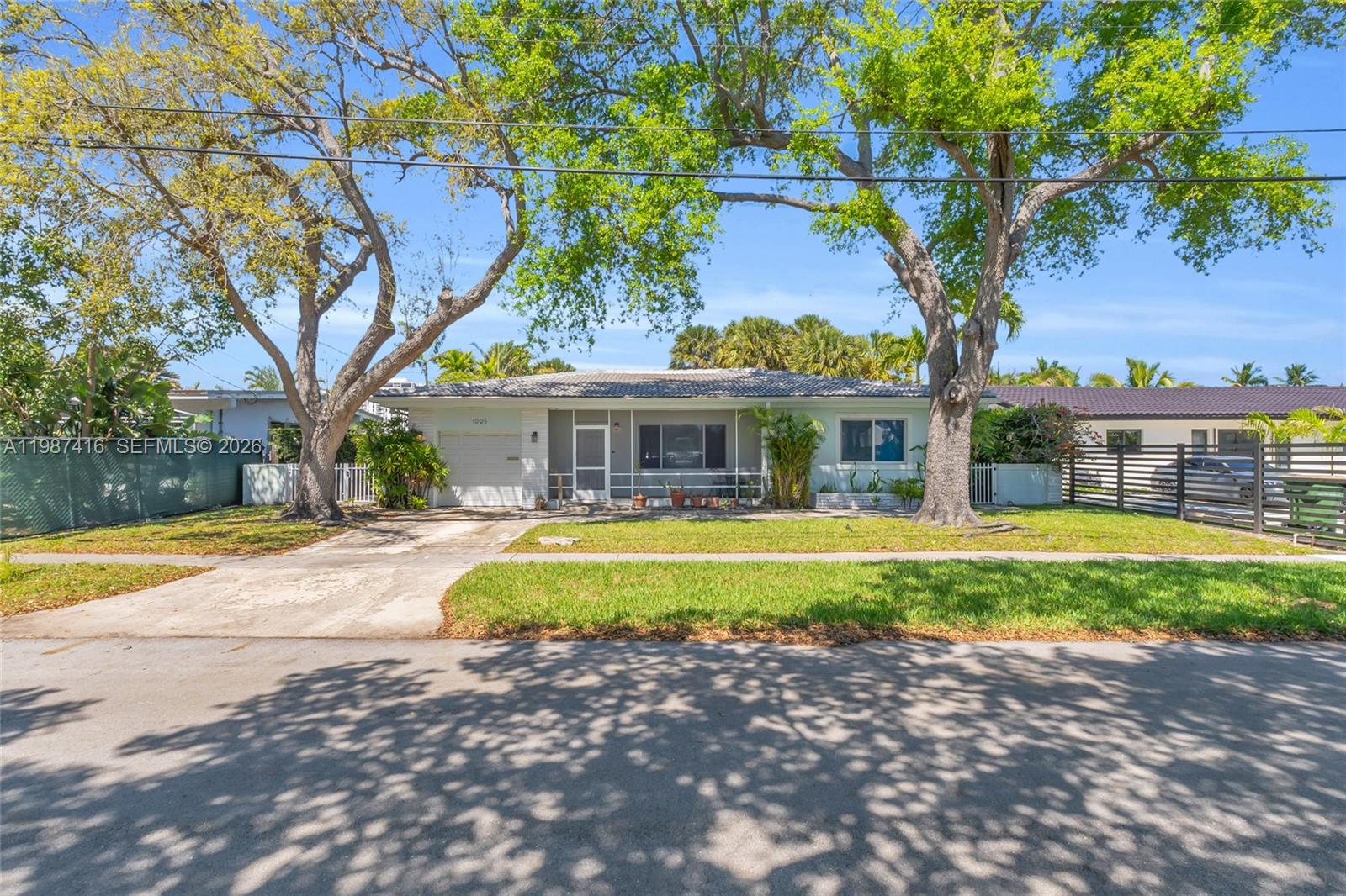 1995 Ixora Road North Miami, FL 33181 - Photo 8 of 30 a house with swimming pool in front of it