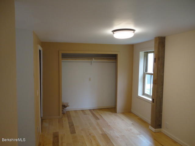 471 River Road Windsor, MA 01270 - Photo 11 of 19 an empty room with wooden floor and a window