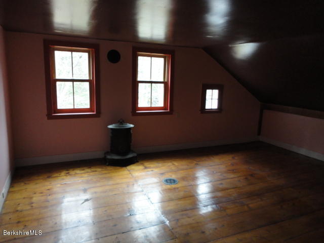 471 River Road Windsor, MA 01270 - Photo 12 of 19 an empty room with wooden floor and windows