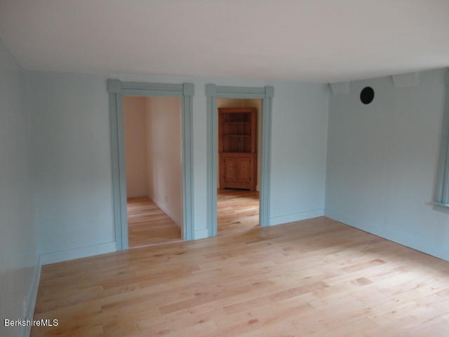 471 River Road Windsor, MA 01270 - Photo 8 of 19 a view of an empty room with wooden floor and a cabinet