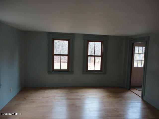 471 River Road Windsor, MA 01270 - Photo 10 of 19 an empty room with wooden floor and windows
