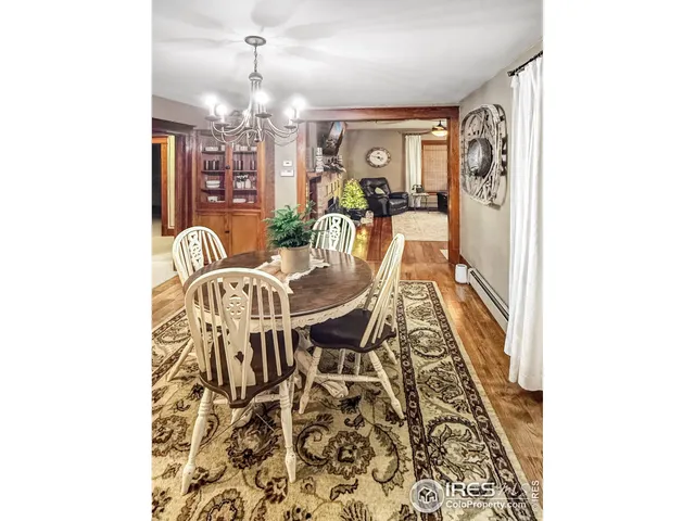 a view of a dining room with furniture and chandelier