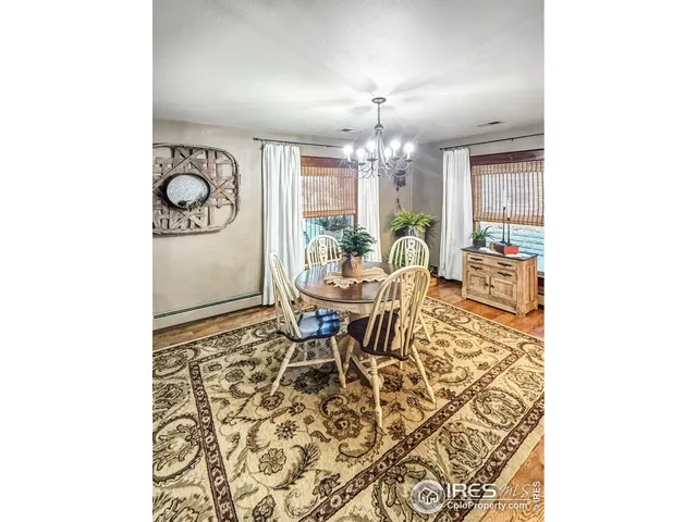 a living room with a table and chairs