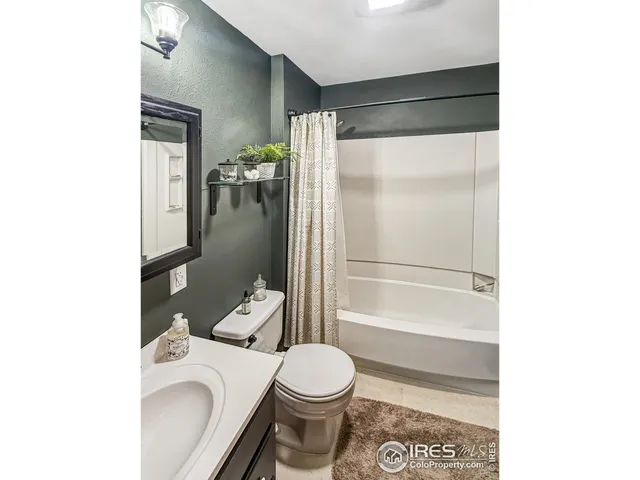 a bedroom with a bed and a ceiling fan