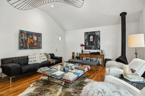 a living room with furniture a rug and a lamp