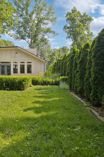 a view of a house with yard and a garden
