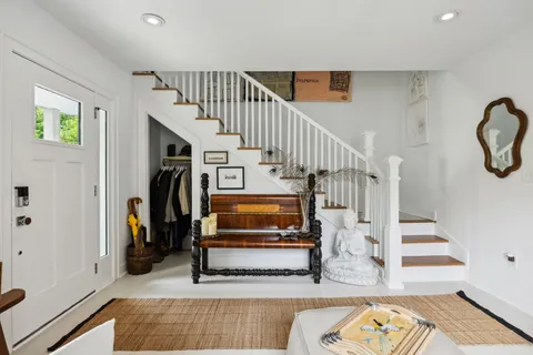 a view of entryway with wooden floor and a rug