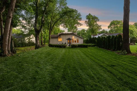 a view of a tree in front of a house