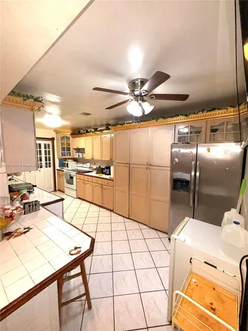 a kitchen with stainless steel appliances kitchen island granite countertop a sink and cabinets