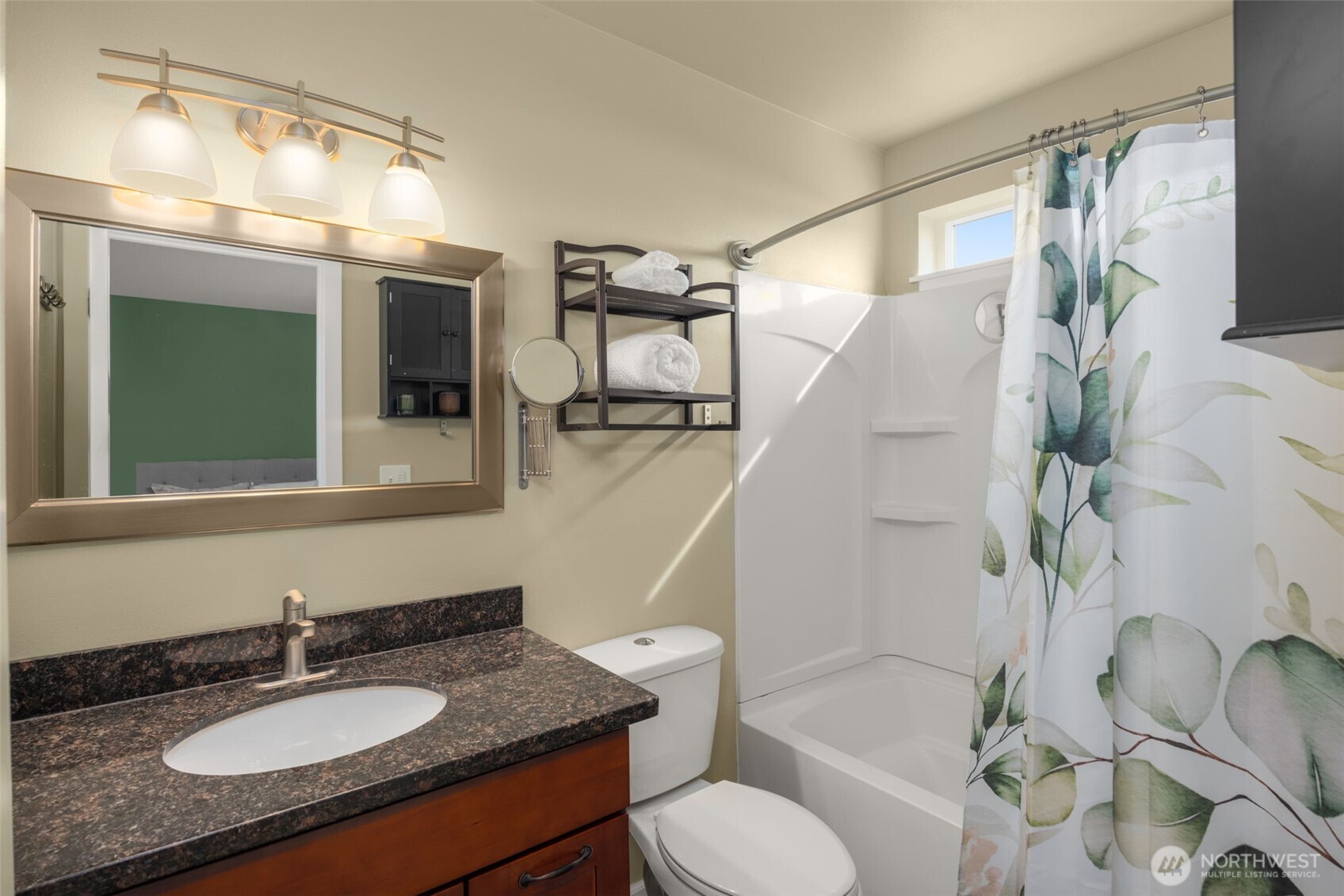 10250 17th Avenue Southwest Seattle, WA 98146 - Photo 15 of 23 a bathroom with a granite countertop sink toilet a mirror and shower