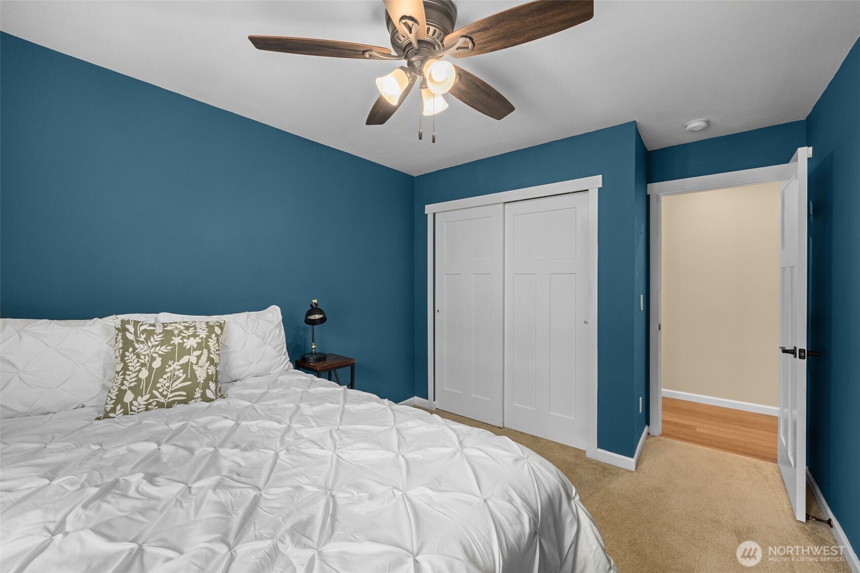 10250 17th Avenue Southwest Seattle, WA 98146 - Photo 16 of 23 a bedroom with a large bed and a ceiling fan
