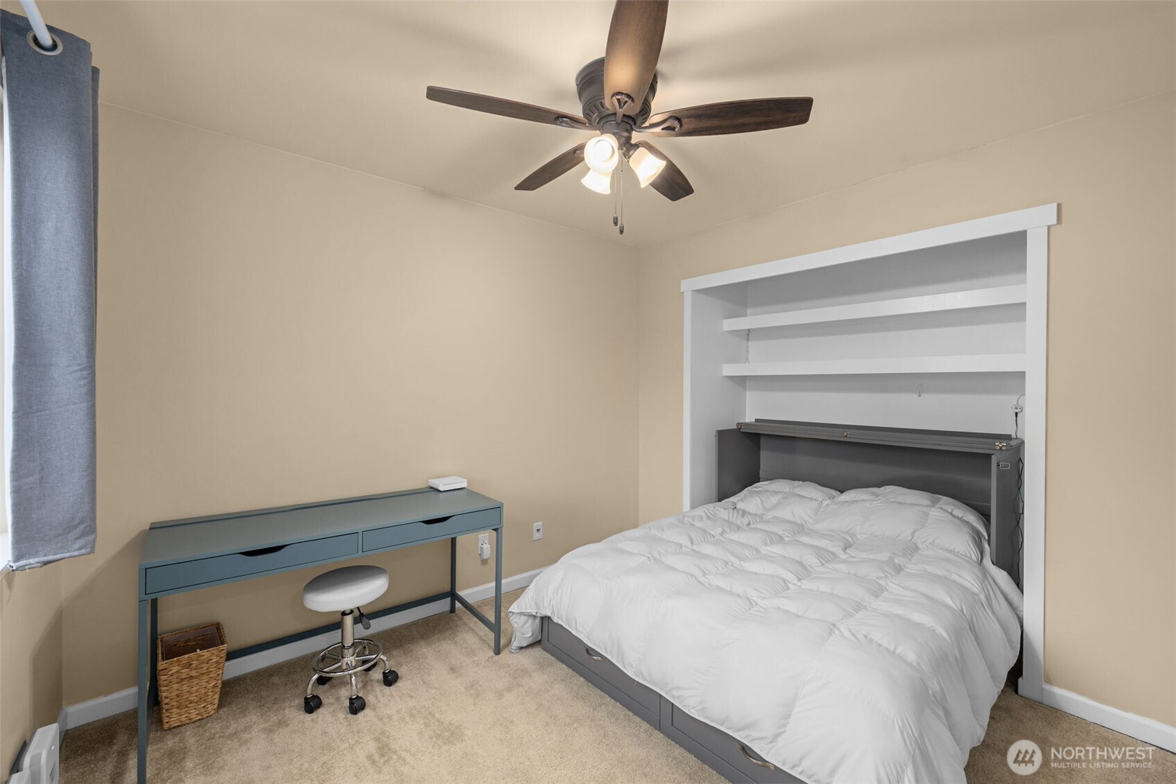 10250 17th Avenue Southwest Seattle, WA 98146 - Photo 18 of 23 a bedroom with a bed and a chandelier