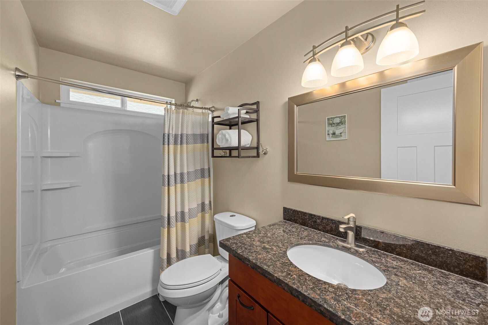 10250 17th Avenue Southwest Seattle, WA 98146 - Photo 19 of 23 a bathroom with a granite countertop sink toilet and shower