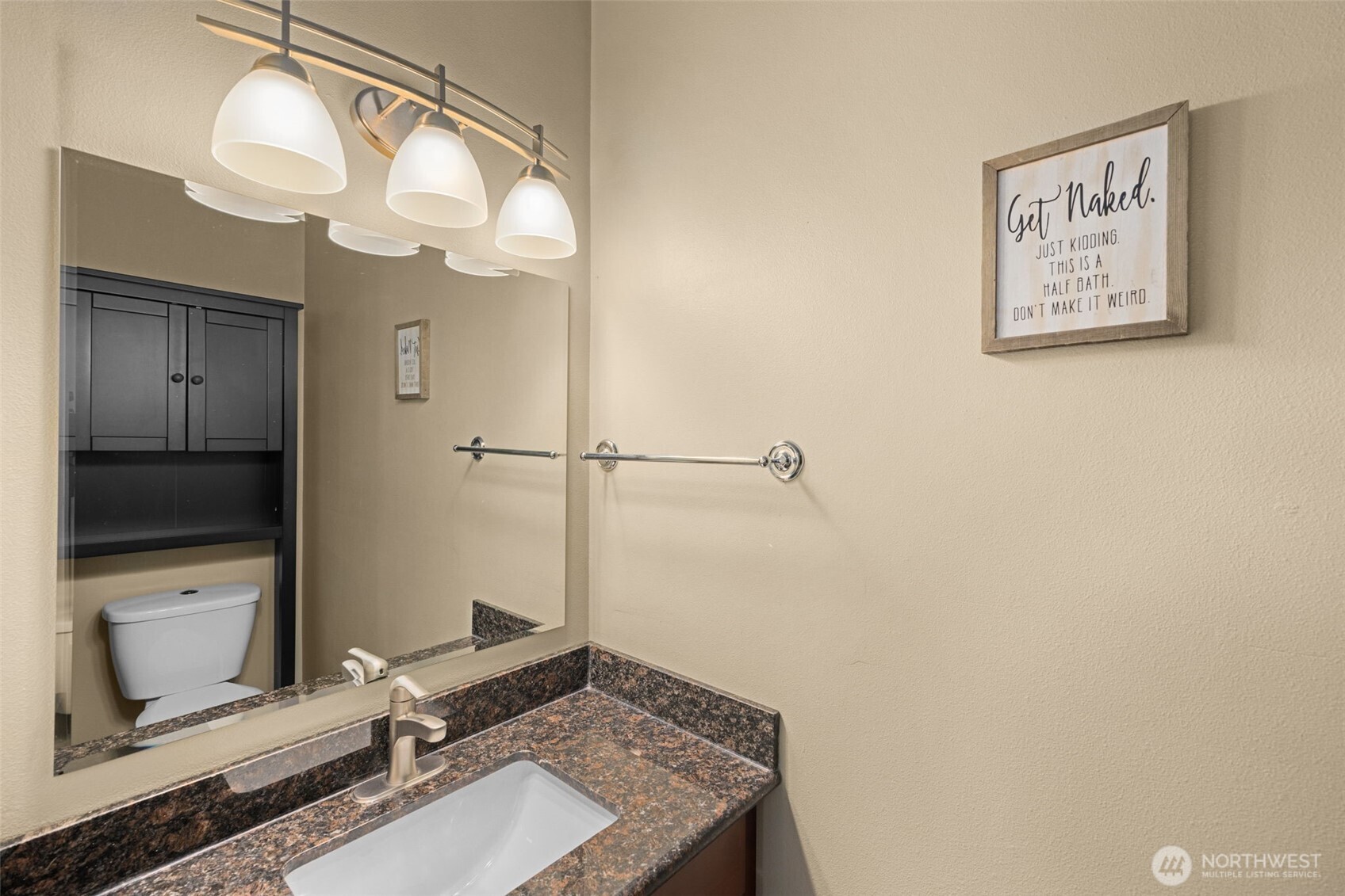 10250 17th Avenue Southwest Seattle, WA 98146 - Photo 8 of 23 a bathroom with a sink a light fixture and a mirror