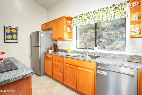 a kitchen with stainless steel appliances granite countertop a refrigerator and a sink