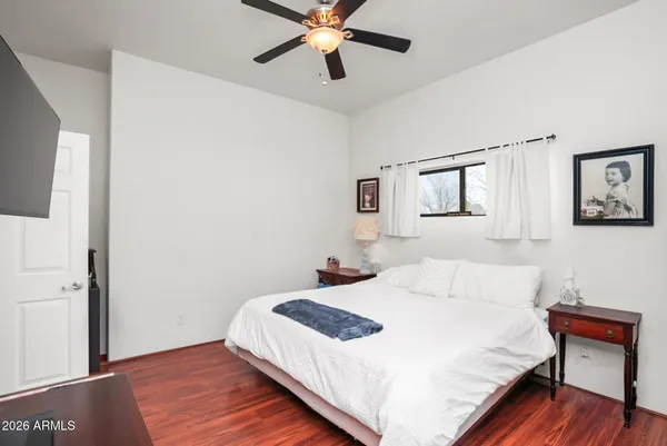 a bedroom with a bed and a chandelier