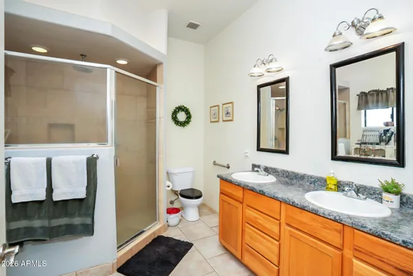 a bathroom with a granite countertop sink mirror and shower