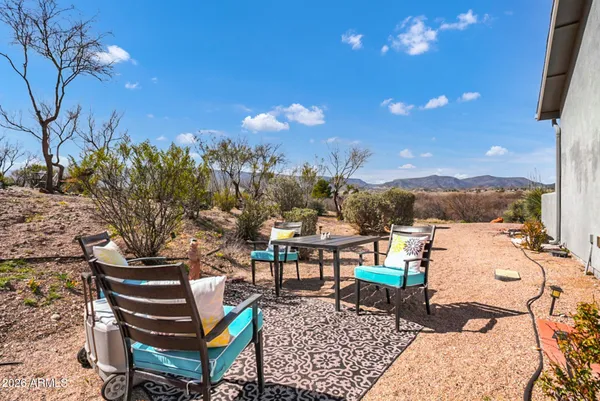 a view of a chairs and table in a patio