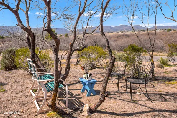 a backyard of a house with table and chairs