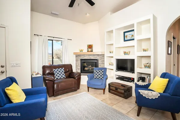 a living room with furniture a rug and a fireplace