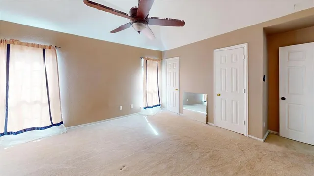 a view of an empty room and a window