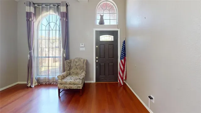 a view of entryway with wooden floor and door