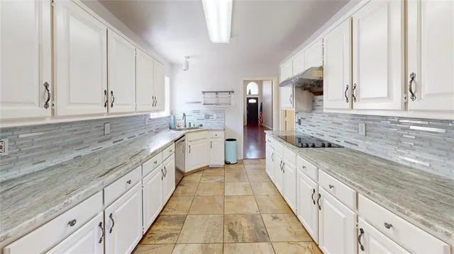 a large kitchen with stainless steel appliances kitchen island granite countertop a sink and cabinets
