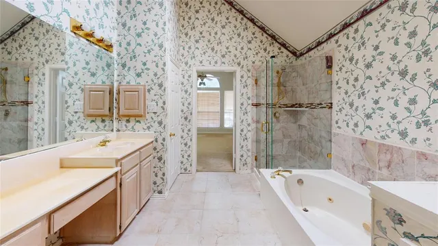 a bathroom with a tub sink and mirror