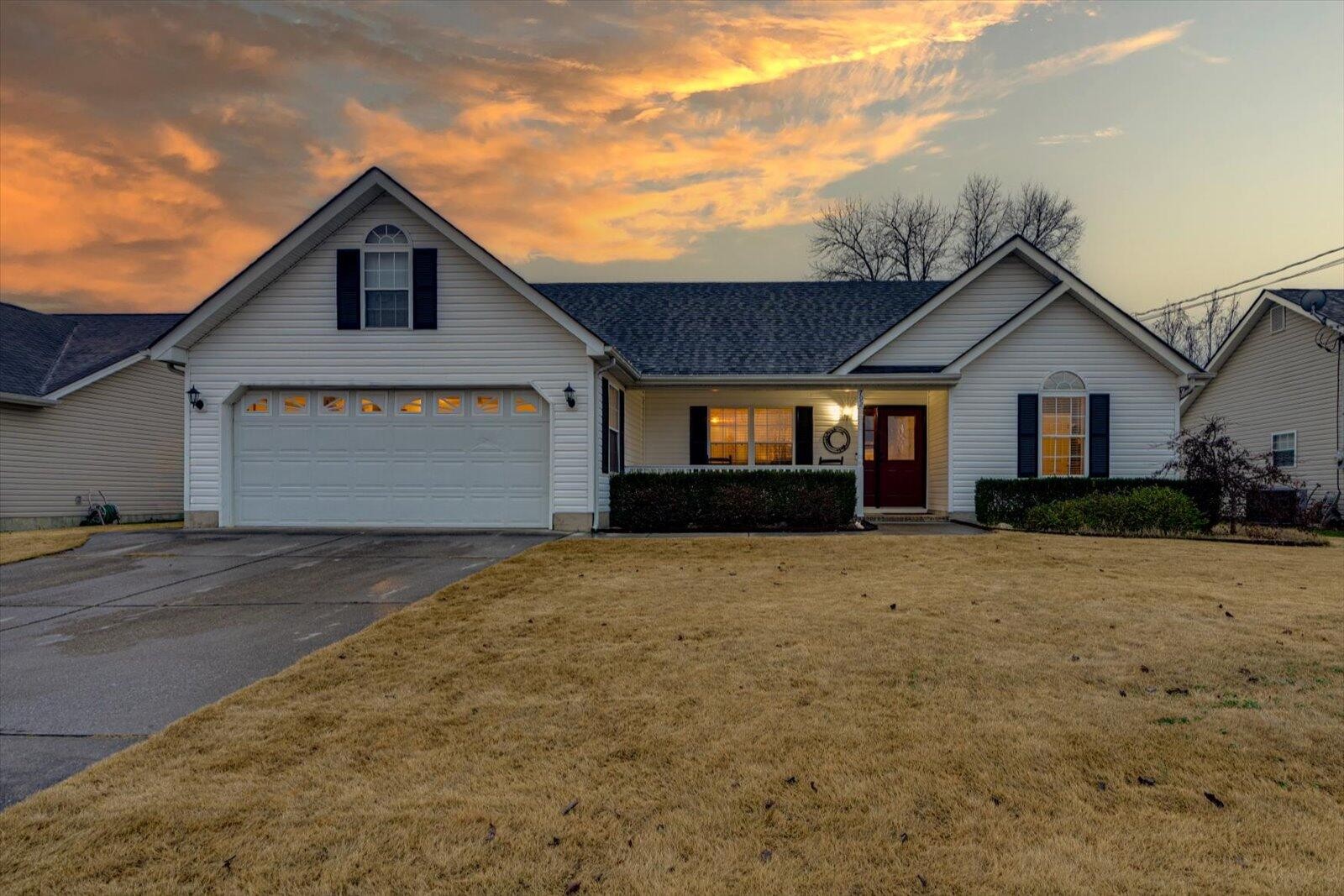 a front view of a house with a yard and garage