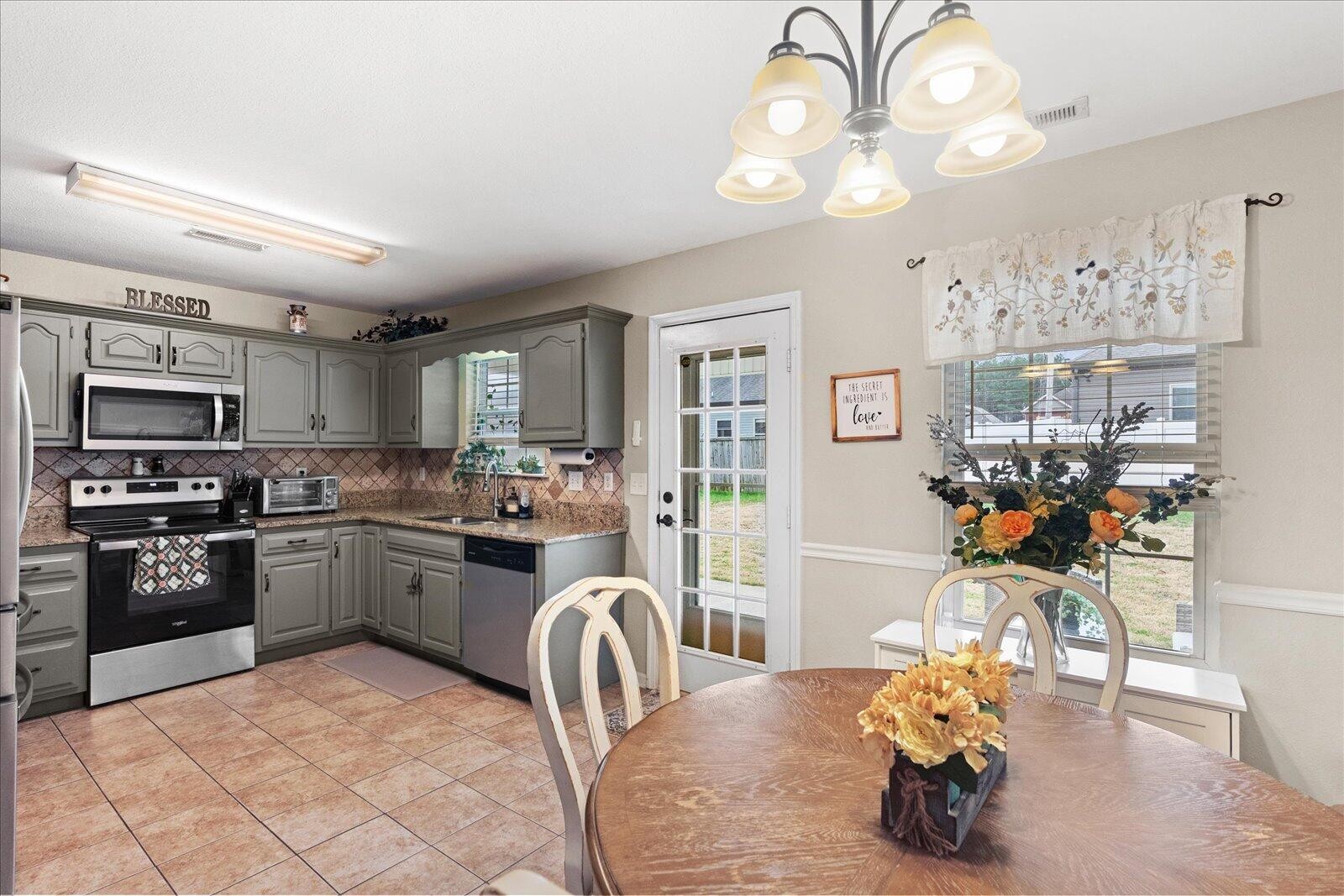 792 Colony Circle Fort Oglethorpe, GA 30742 - Photo 12 of 36 a kitchen with granite countertop a sink cabinets and stainless steel appliances