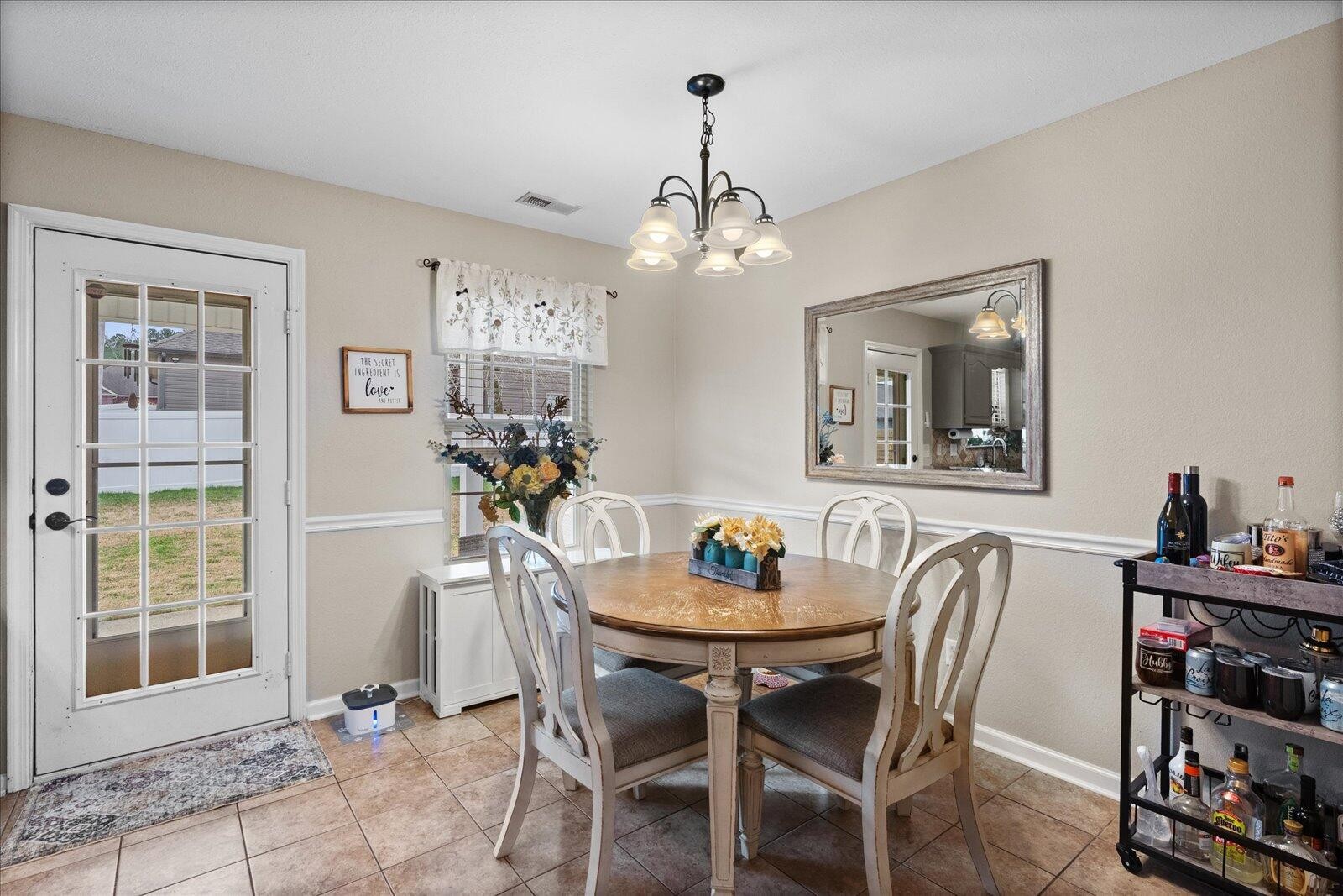 792 Colony Circle Fort Oglethorpe, GA 30742 - Photo 14 of 36 a view of a dining room with furniture and chandelier