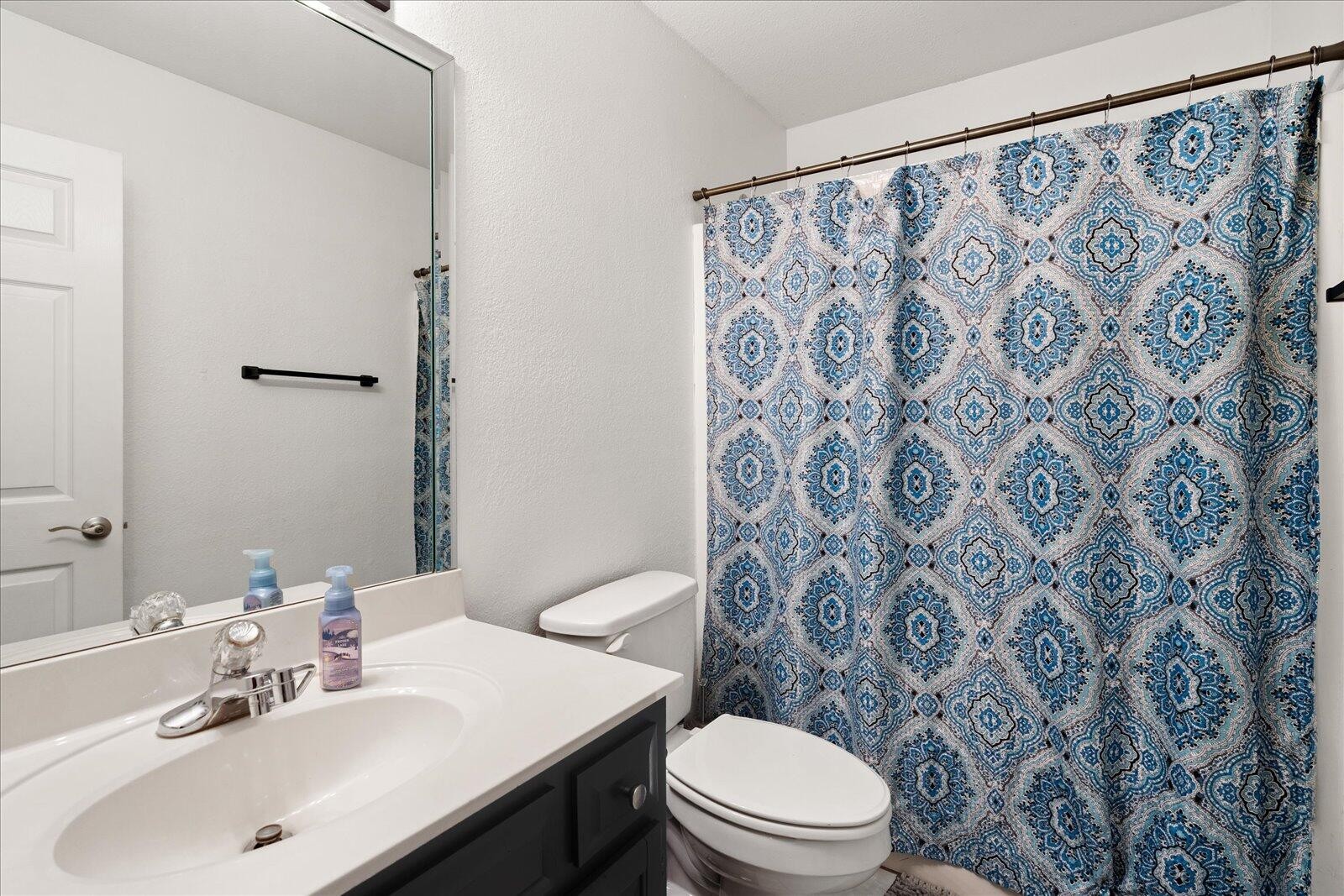 792 Colony Circle Fort Oglethorpe, GA 30742 - Photo 18 of 36 a bathroom with a toilet sink and mirror
