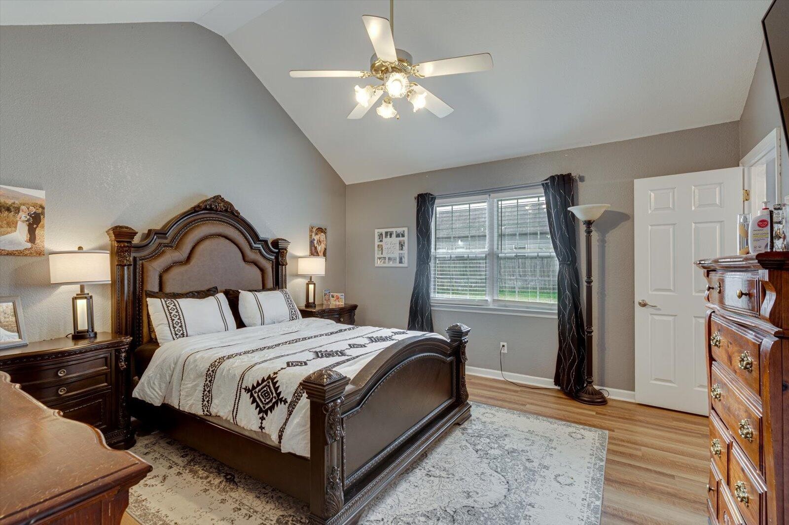 792 Colony Circle Fort Oglethorpe, GA 30742 - Photo 21 of 36 a bedroom with a bed a window and a chandelier