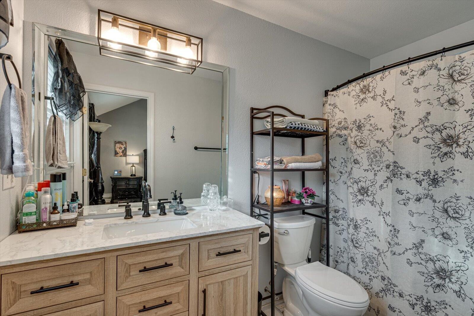 792 Colony Circle Fort Oglethorpe, GA 30742 - Photo 22 of 36 a bathroom with a sink a toilet and a mirror