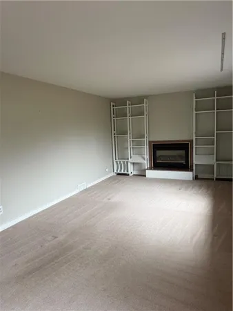 a view of an empty room with a fireplace