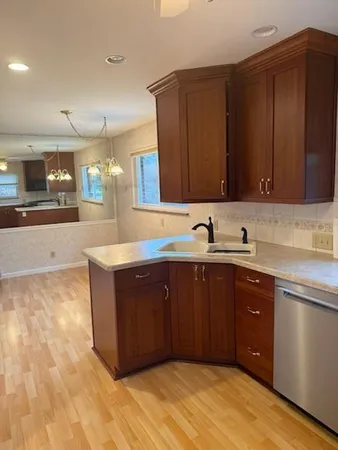 a kitchen with stainless steel appliances granite countertop a sink and cabinets