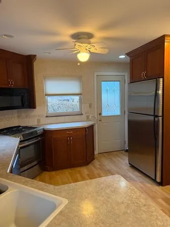 a kitchen with a refrigerator and a sink