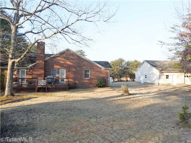 7502 Alcorn Road Greensboro, NC 27409 - Photo 4 of 16 Exterior Back. The rear offers a great deck overlooking the backyard!